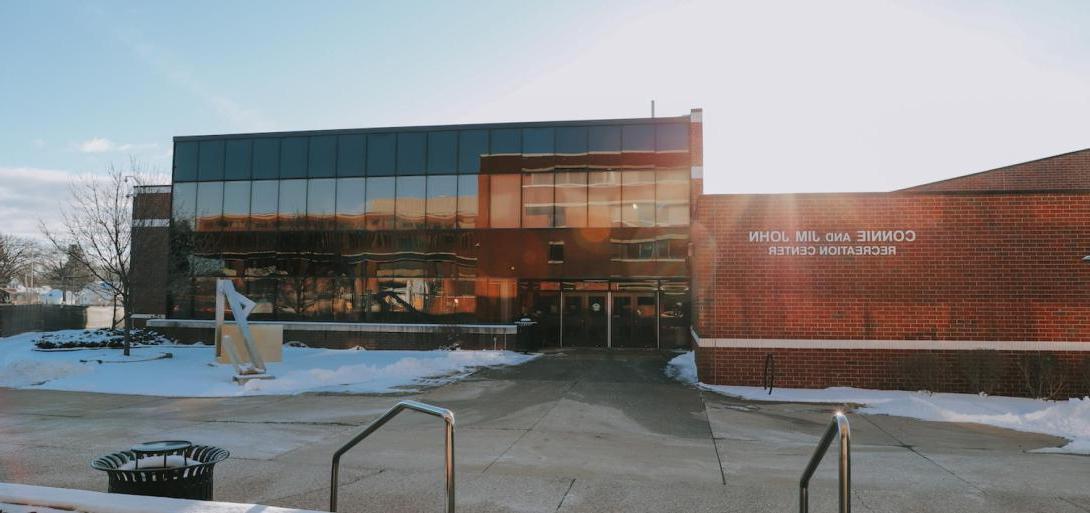 Exterior view of the Connie and Jim John Recreation Center at Kettering University on a sunny winter day.